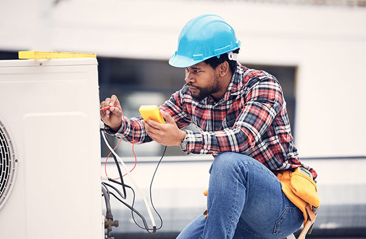 An HVAC tech working on a system