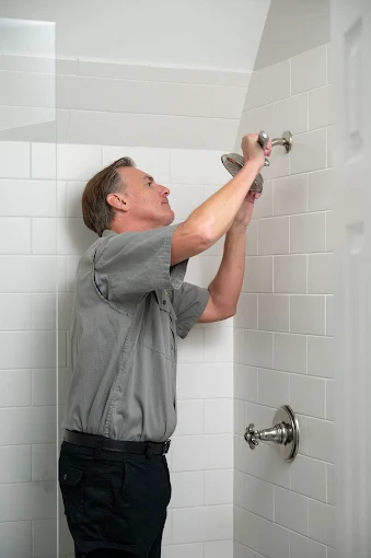 A plumber working on a shower