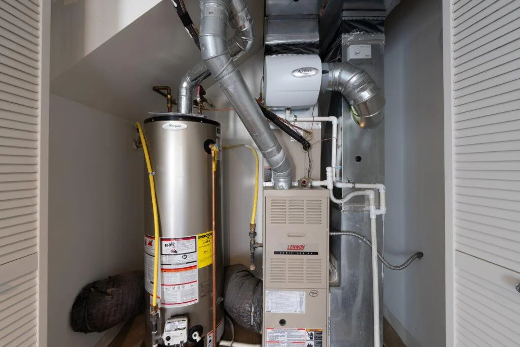 Furnace, water heater, and ductwork in a utility closet