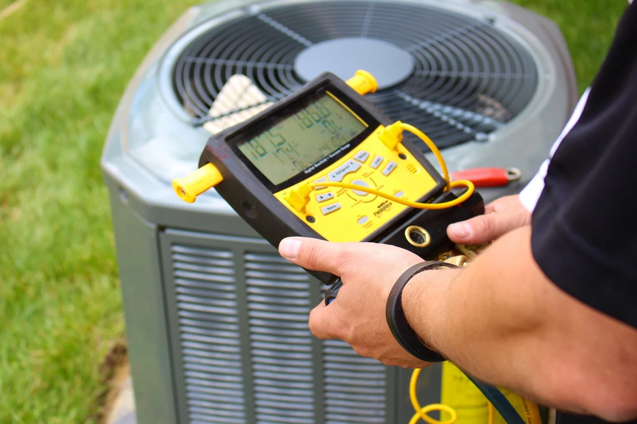 An HVAC tech working on an HVAC unit
