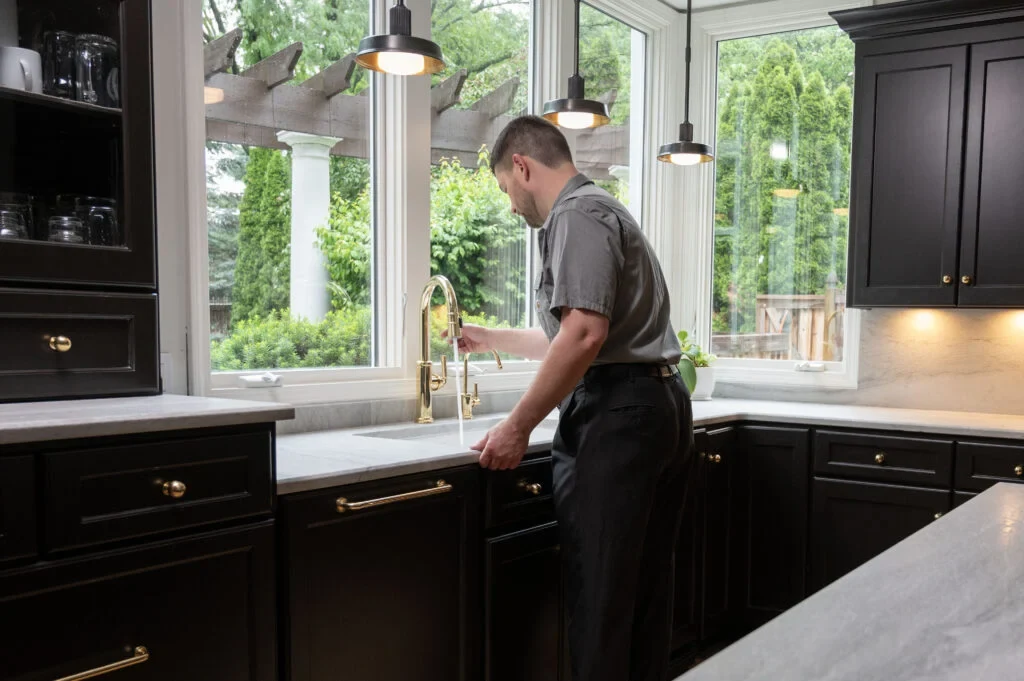 Davison technician working at a kitchen sink
